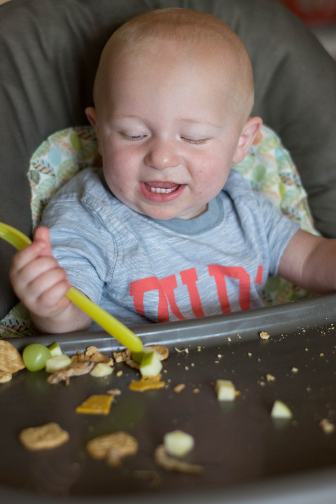 I'm lucky he's so happy-go-lucky...or he'd be pissed he can't pick up the apple. Instead, this kid smiles because he's making contact with the fork and the food.