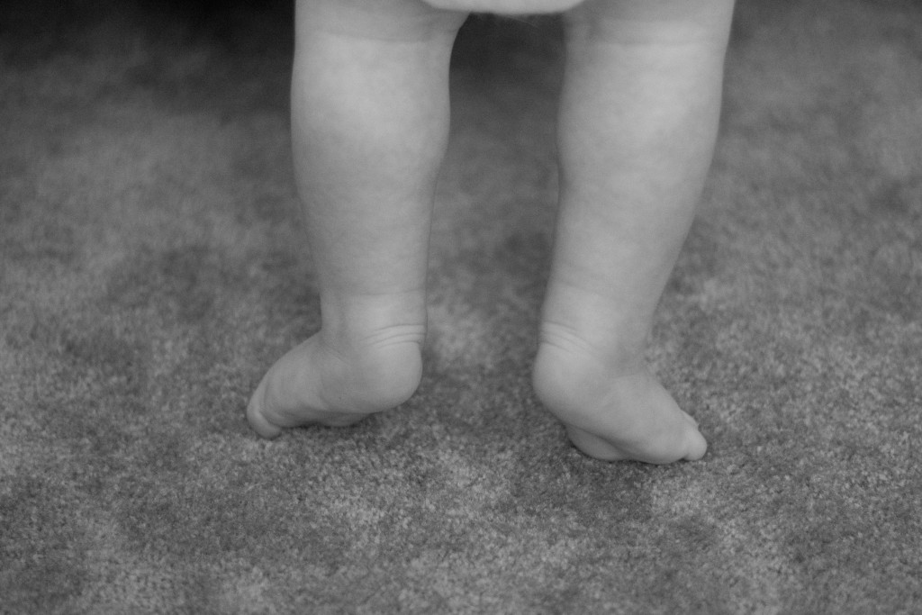 Liam on his tippy toes trying to reach for things.