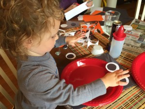 Emma putting on eyes for Elmo