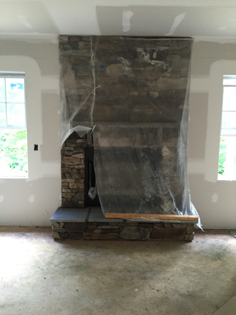 Fire place sneak peek...covered to keep it from getting paint on it. I can't imagine it's fun to get paint off of stone.